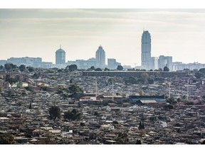 Skyscraper office buildings in Sandton beyond Alexandra township in Johannesburg, South Africa.