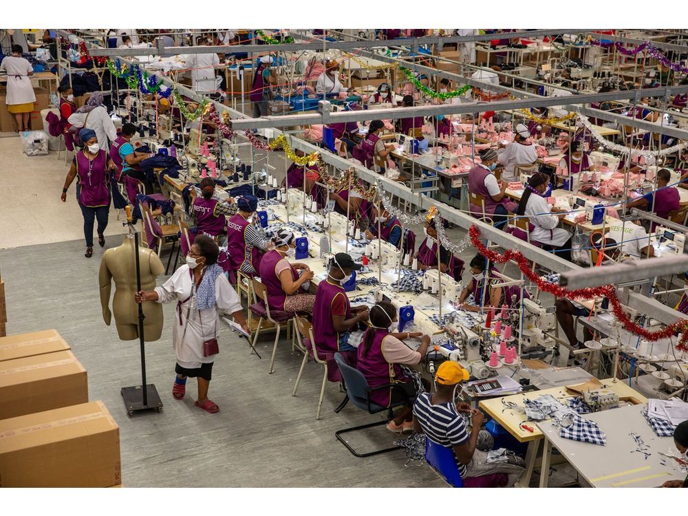 Workers sew garments on machines at the Prestige Clothing (Pty) Ltd. textile factory, operated by The Foschini Group Ltd., in the Maitland district of Cape Town, South Africa, on Thursday, Dec. 10, 2020. South African retailers including The Foschini Group and Woolworths Holdings Ltd. are increasing investment in local clothing manufacturers -- both to reduce a dependency on Chinese imports and secure a supply chain thrown into disarray by Covid-19 restrictions.