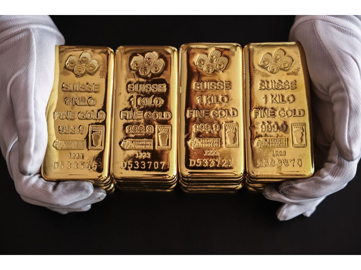 An employee handles one kilogram gold bullions at the YLG Bullion International Co. headquarters in Bangkok, Thailand, on Friday, Dec. 22, 2023. Gold headed for a weekly gain after US price data came in cooler than forecast, reinforcing expectations for multiple interest rate cuts by the Federal Reserve next year.