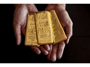 An employee holds one kilogram gold bullions at the YLG Bullion International Co. headquarters in Bangkok, Thailand, on Friday, Dec. 22, 2023. Gold headed for a weekly gain after US price data came in cooler than forecast, reinforcing expectations for multiple interest rate cuts by the Federal Reserve next year.