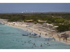 Tourists at Bahia de las Aguilas beach in Cabo Rojo, Pedernales Province, Dominican Republic.