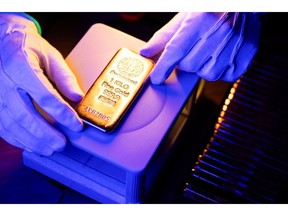 An attendant weighs a one kilogram gold bar at Conclude Zrt bullion dealer arranged in Budapest, Hungary, on Thursday, Jan. 22, 2026. Gold closed in on $5,000 an ounce, with geopolitical risks and renewed threats to the Federal Reserve's independence supporting a record-breaking rally.