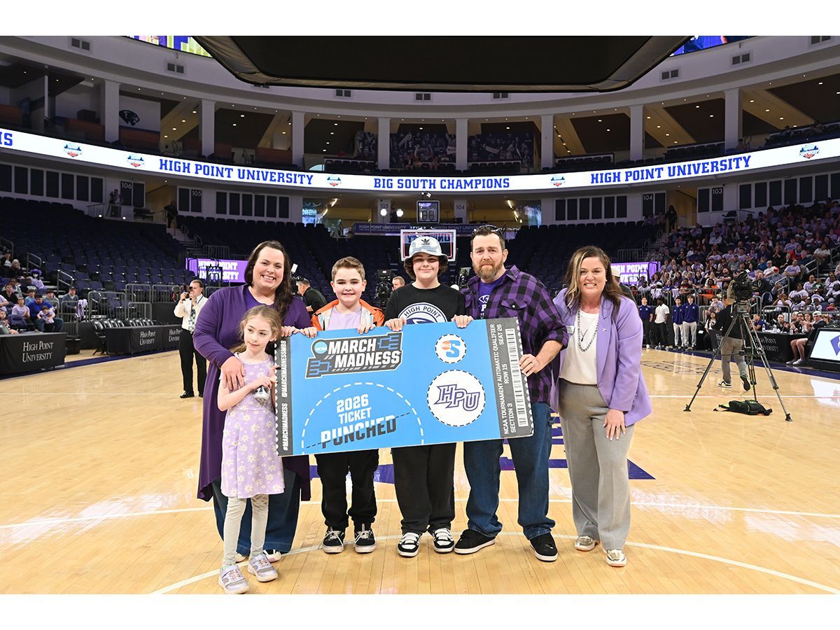 High Point University surprised a local family with an all-expenses-paid trip to watch the Panthers play in the first round of the NCAA Tournament in Portland, Oregon. Pictured from left were Alexis Ford with her daughter, Trinity Ford, and sons Austin and Jacob Ford as they stood next to their father, Jimmy Ford, and Lyndsey Ayers, HPU's vice president for university relations. They were surprised during HPU's special NCAA Tournament watch party at the Nido and Mariana Qubein Arena and Conference on March 15.