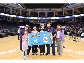 High Point University surprised a local family with an all-expenses-paid trip to watch the Panthers play in the first round of the NCAA Tournament in Portland, Oregon. Pictured from left were Alexis Ford with her daughter, Trinity Ford, and sons Austin and Jacob Ford as they stood next to their father, Jimmy Ford, and Lyndsey Ayers, HPU's vice president for university relations. They were surprised during HPU's special NCAA Tournament watch party at the Nido and Mariana Qubein Arena and Conference on March 15.