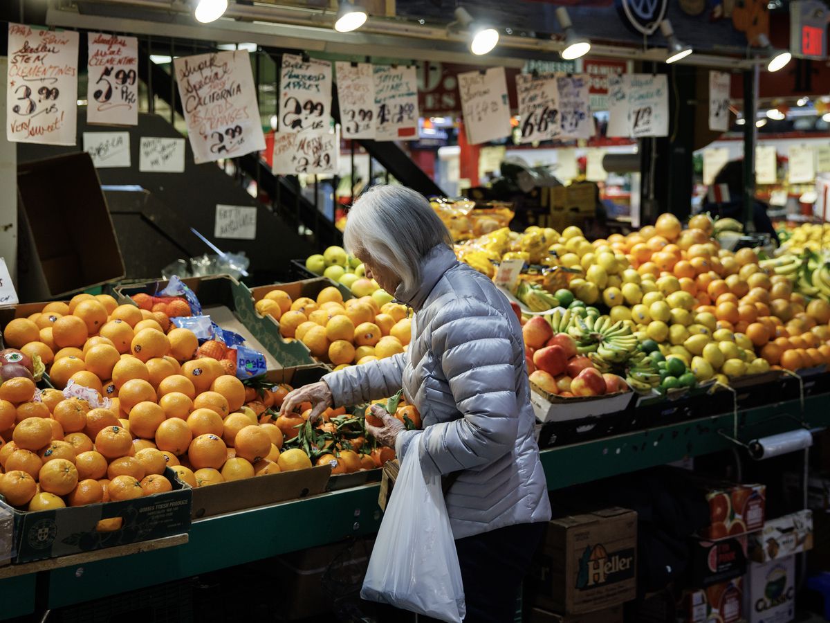 A shopper at a produce counter in St. Lawrence Market in Toronto.