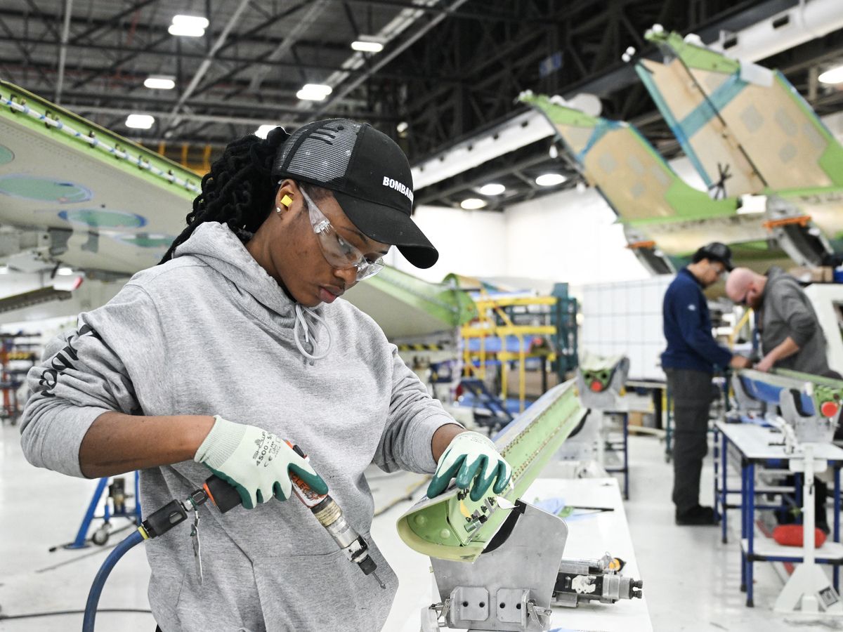  Workers assemble a Bombardier Challenger aircraft under construction at the Bombardier manufacturing facility in Montreal, Quebec, Canada on February 18, 2025.