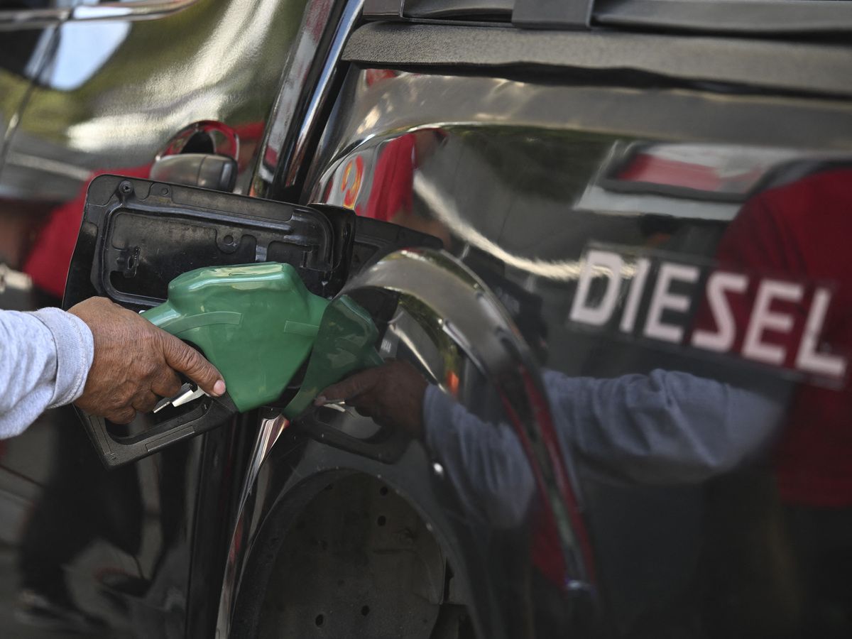 A worker fills the tank of a diesel car at a gas station in Guatemala City on March 19, 2026.