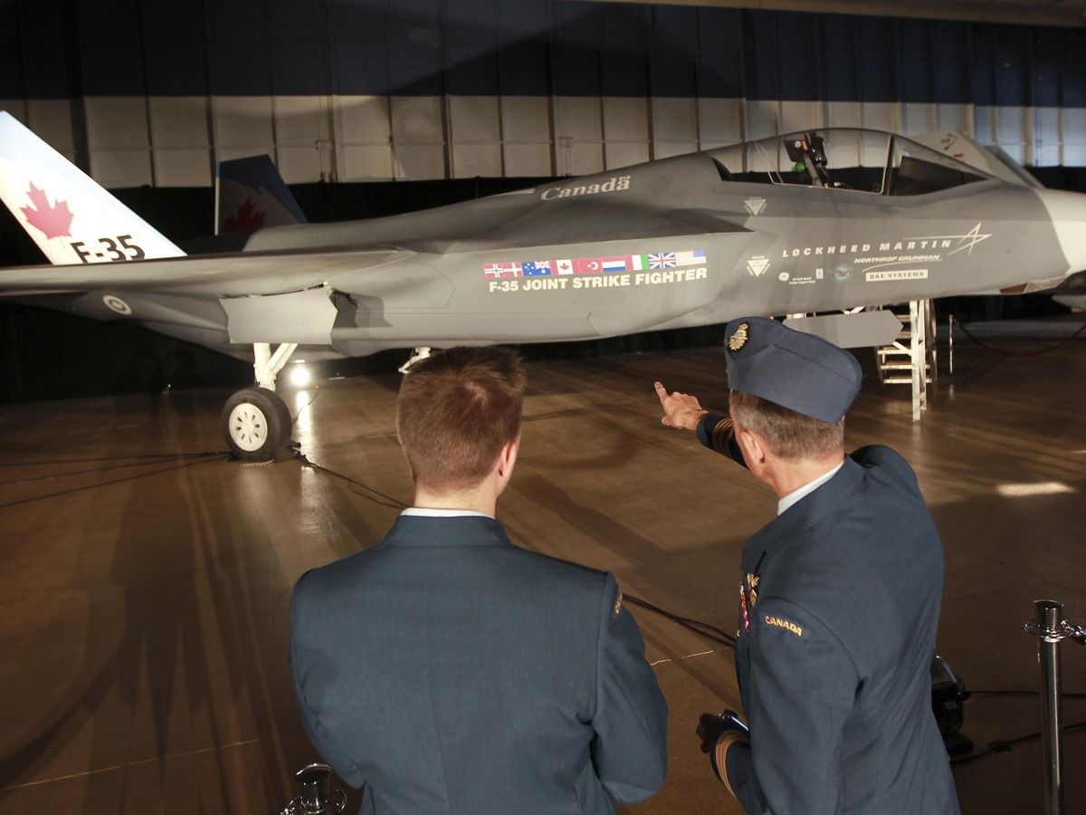 Two Canadian Forces members look at the Lockheed Martin Joint Strike Fighter, F-35 Lighting II in a hanger in Ottawa,  during the original purchase announcement on July 16, 2010.