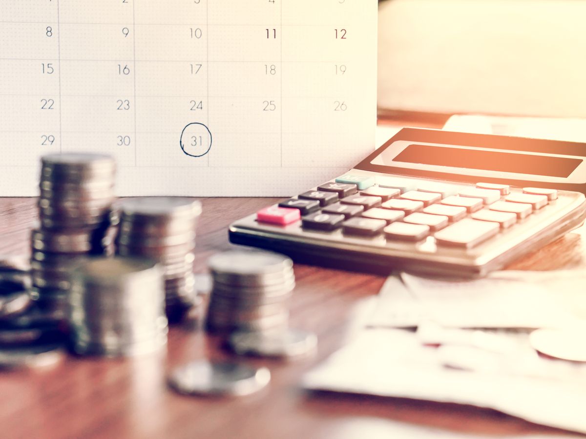 debt collection and tax season concept with deadline calendar remind note,coins,banks,calculator on table, background ,time to pay concept