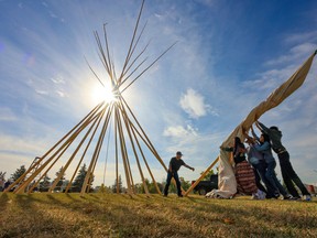 Kanai First Nation members raise a tipi at The Confluence on Monday, September 29, 2025.