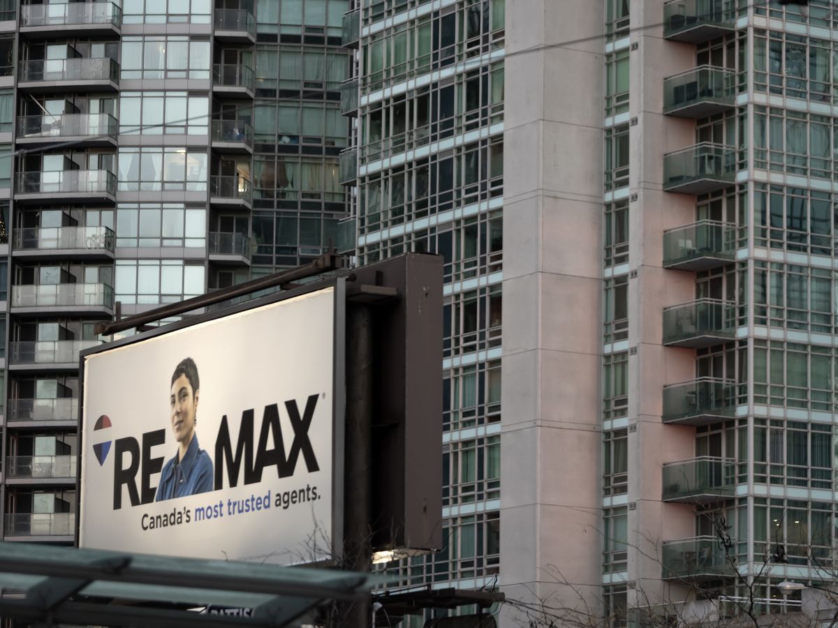 A Remax advertisment in front of condos in Toronto at Spadina Avenue and Front Street in Toronto, Tuesday December 2, 2025.