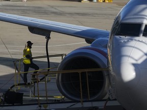 Virgin Australia ground crew attend to a Virgin Australia aircraft prior to departure at Melbourne Airport on April 18, 2026 in Melbourne, Australia.
