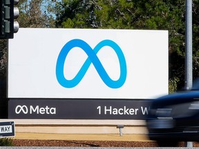 A car passes Facebook's new Meta logo on a sign at the company headquarters on Oct. 28, 2021, in Menlo Park, Calif.