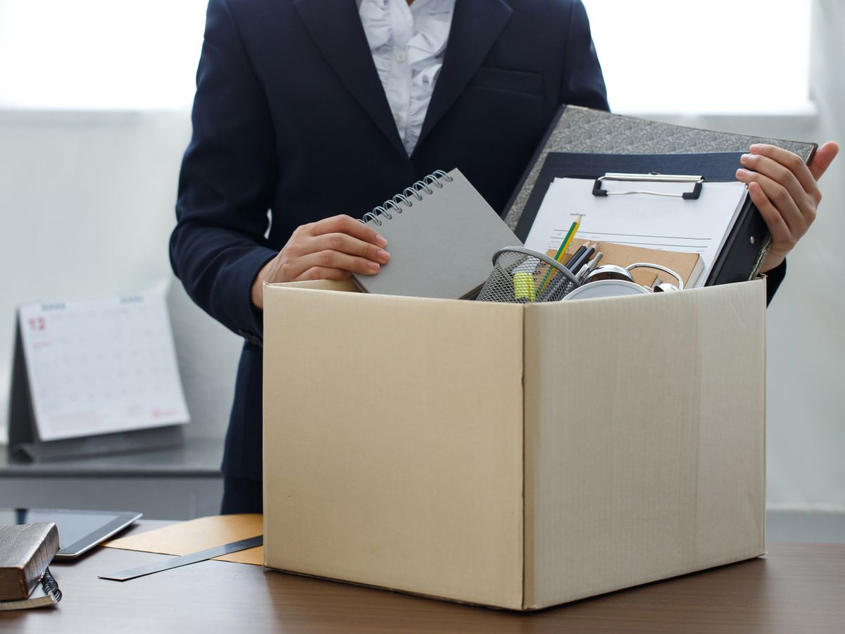 Businesswoman packing personal company belongings when she deciding resignation change of job or fired from the company.