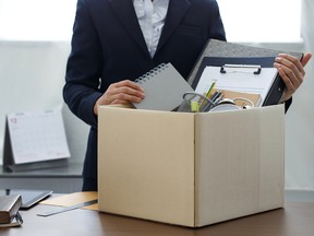 Businesswoman packing personal company belongings when she deciding resignation change of job or fired from the company.