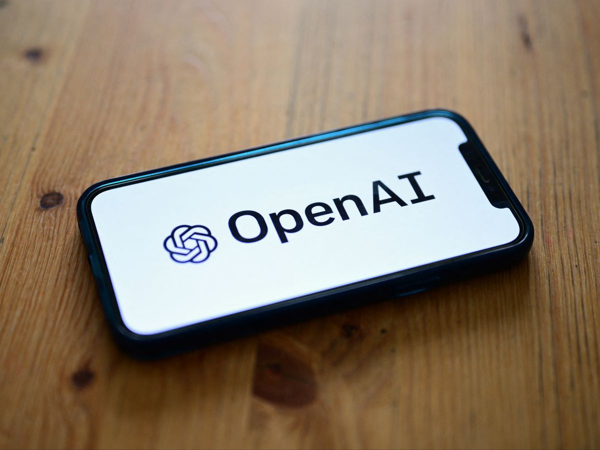 A photo taken on October 4, 2023 in Manta, near Turin, shows a smartphone displaying the logo of the artificial intelligence OpenAI research laboratory.