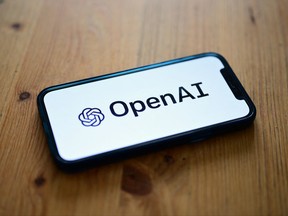 A photo taken on October 4, 2023 in Manta, near Turin, shows a smartphone displaying the logo of the artificial intelligence OpenAI research laboratory.