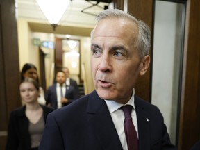 Prime Minister Mark Carney walks to the House of Commons to introduce new Members of Parliament on Parliament Hill in Ottawa April 27, 2026.
