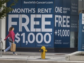 A person walks past a Concert Properties The Kip District advertisement promoting