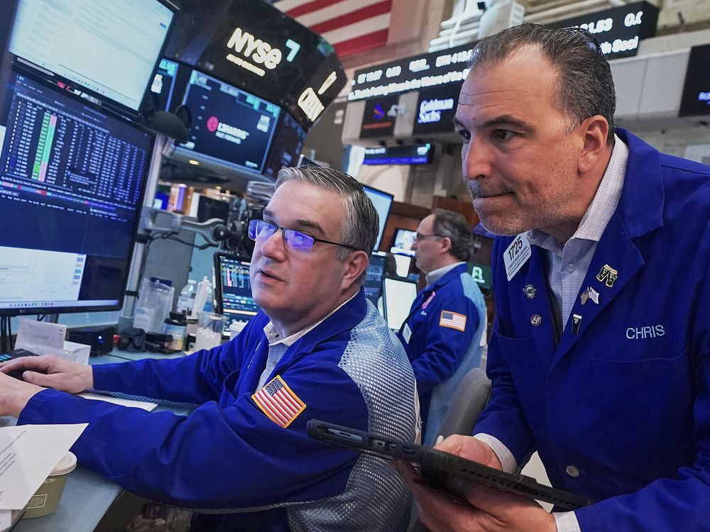Traders Jim Bodner, left, and Chris Lagana work on the floor of the New York Stock Exchange, Thursday, April 23, 2026.