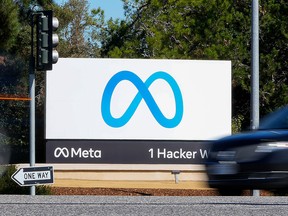 A car passes Facebook's new Meta logo on a sign at the company headquarters on Oct. 28, 2021, in Menlo Park, Calif.