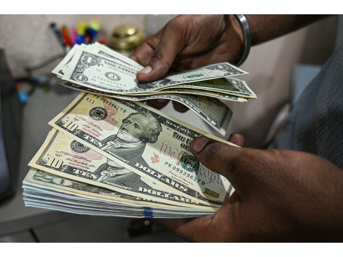 An employee counts US dollar banknotes