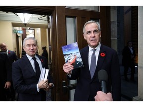 Mark Carney, right, and Francois-Philippe Champagne before releasing the federal budget in Ottawa on Nov. 4.