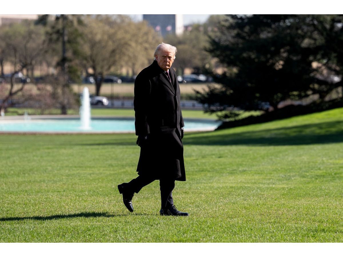 US President Donald Trump walks on the South Lawn of the White House in March.
