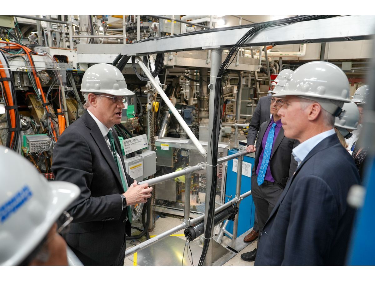Richard Buttery, senior director of the DIII-D National Fusion Facility (right) stands with Chris Wright, U.S Secretary of Energy (right) outside DIII-D's tokamak