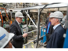 Richard Buttery, senior director of the DIII-D National Fusion Facility (right) stands with Chris Wright, U.S Secretary of Energy (right) outside DIII-D's tokamak