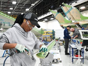Workers assemble a Bombardier Challenger aircraft in Montreal. Preliminary estimates for the first quarter of 2026 suggests the economy grew by 0.4 per cent.