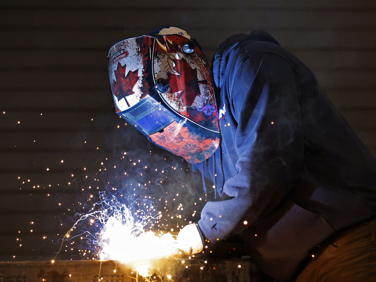 A worker welds a dump body cargo bed at a manufacturing facility in Vars, Ontario May 4, 2026.