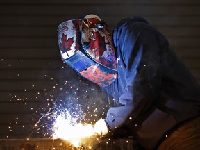 A worker welds a dump body cargo bed at a manufacturing facility in Vars, Ontario May 4, 2026.