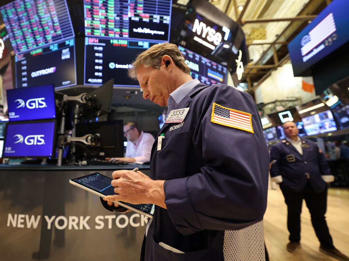 Traders work on the floor of the New York Stock Exchange (NYSE) at the opening bell in New York, on April 20, 2026.