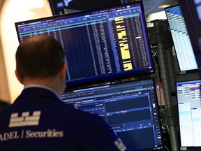 A trader works on the floor of the New York Stock Exchange (NYSE) at the opening bell in New York on April 30, 2026.