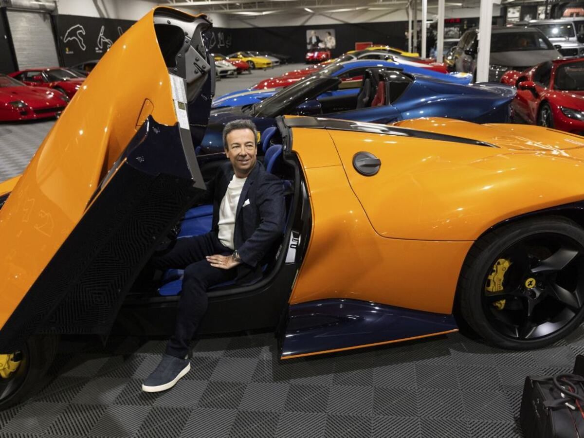 Luc Poirier, a real estate tycoon in Quebec, sits in one of his 35 ferraris at his warehouse in La Prairie, Quebec. His collection is valued at over $90 million.