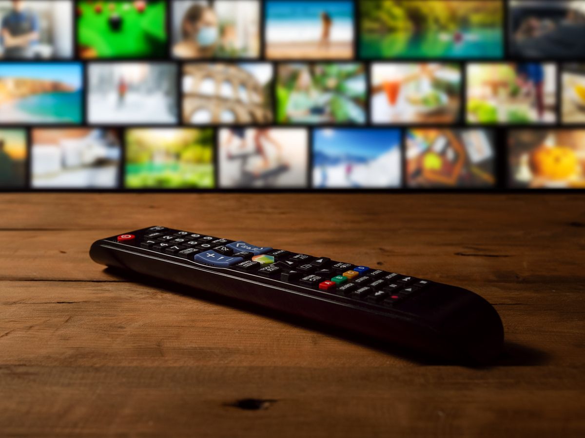 smart tv interactive television - channel collage with remote control on the table