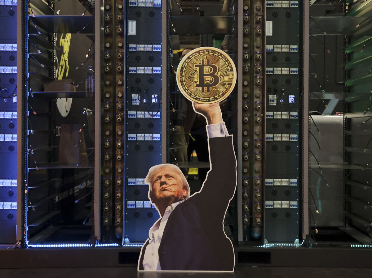 A cutout of US President Donald Trump holding a Bitcoin is displayed on a group of servers during The Bitcoin Conference at The Venetian Las Vegas in Las Vegas, Nevada, on May 27, 2025.
