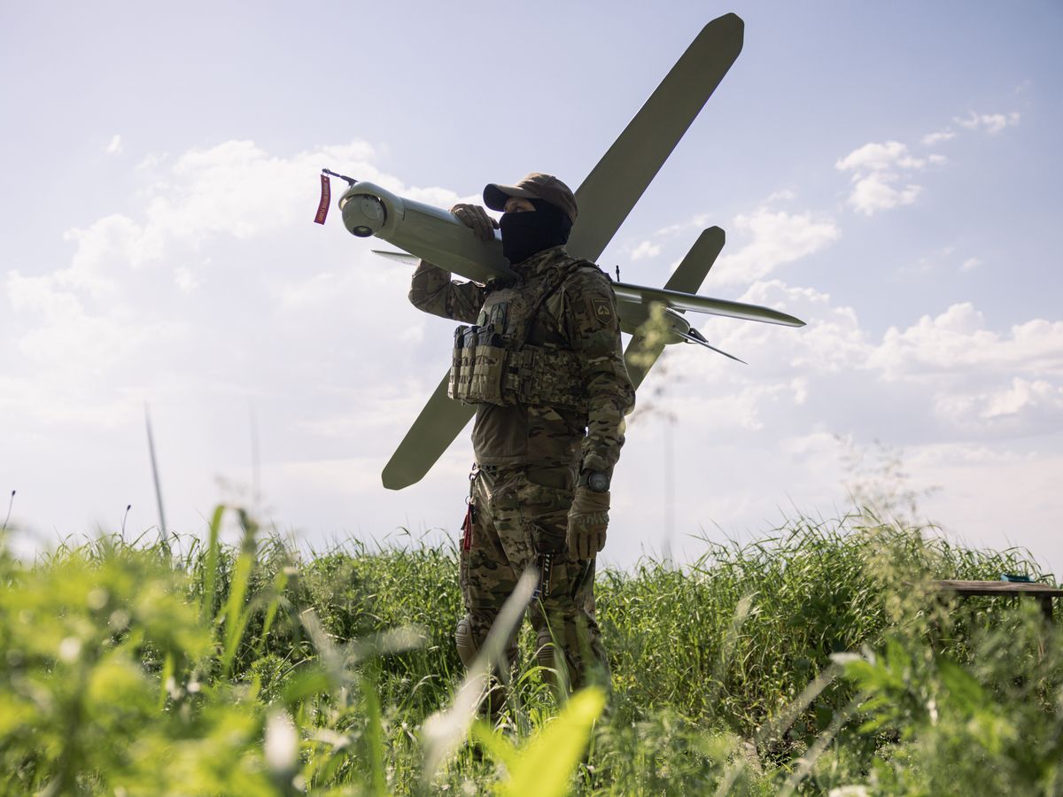 Members of the Lava Unmanned Systems Regiment, Norman, poses for a photograph with a Bulava strike drone, a kamikaze UAV capable of carrying a 3.5-kilogram payload with a range of up to 100 kilometres, on May 22, 2026 in Kharkiv region, Ukraine.