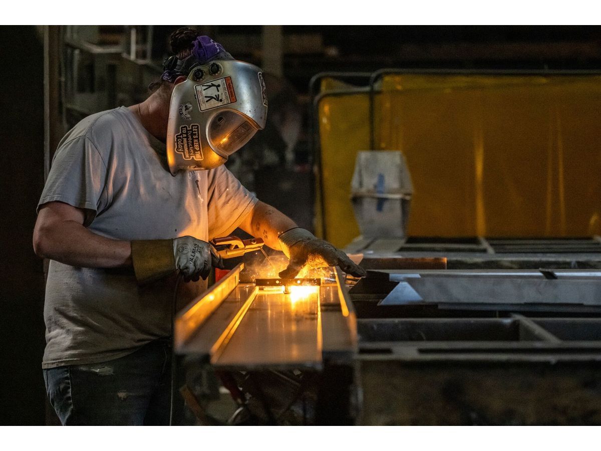 A worker arc welds a metal door during production at a manufacturing facility in Sacramento, California.