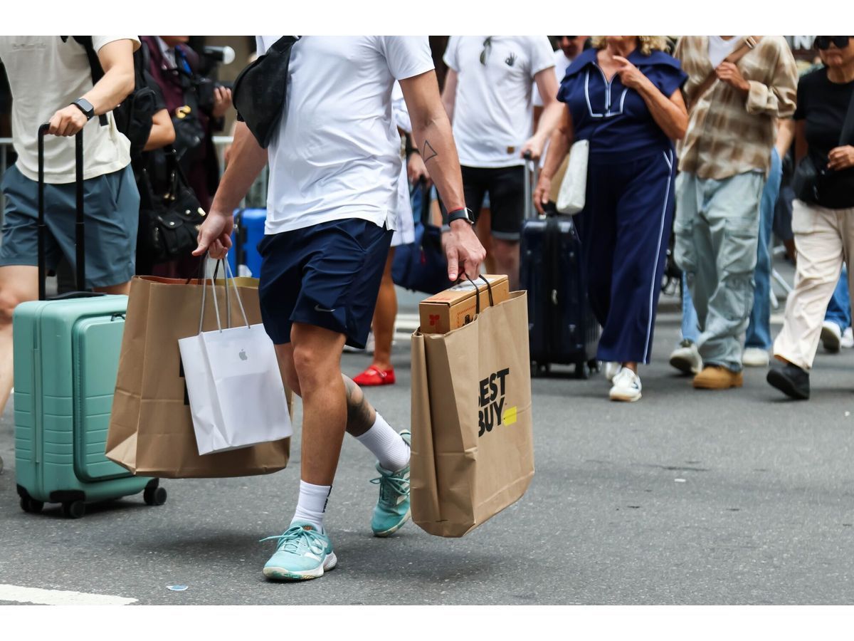 A shopper carries Best Buy store bags in New York.