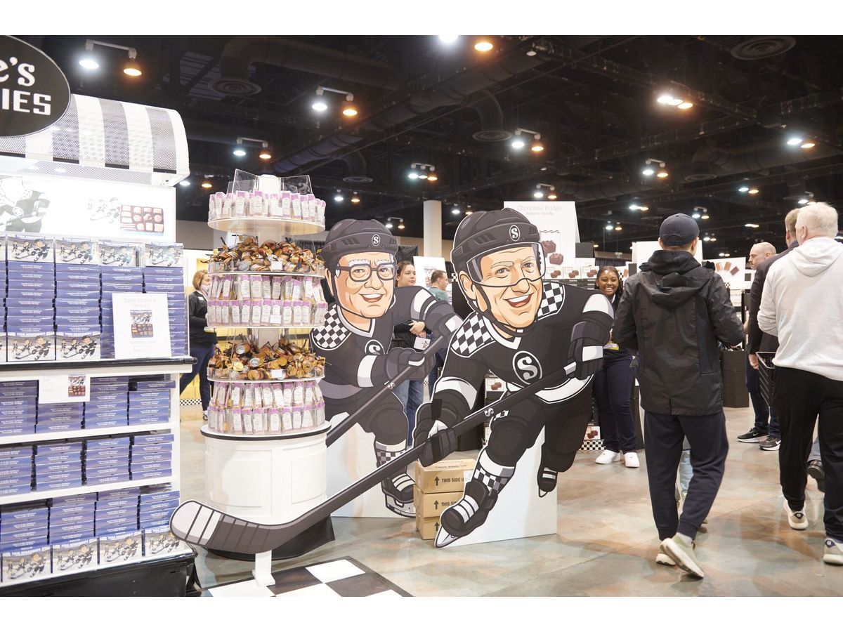 Cutouts depicting former Berkshire Hathaway CEO Warren Buffet and Berkshire Hathaway CEO Greg Abel at the See's Candies booth inside the convention hall during a shareholders shopping day ahead of the Berkshire Hathaway annual shareholders meeting in Omaha, Nebraska, US, on Friday, May 1, 2026. CEO Greg Abel has pledged to follow Buffett's approach to investing and managing risk - Saturday's meeting is branded with the slogan 