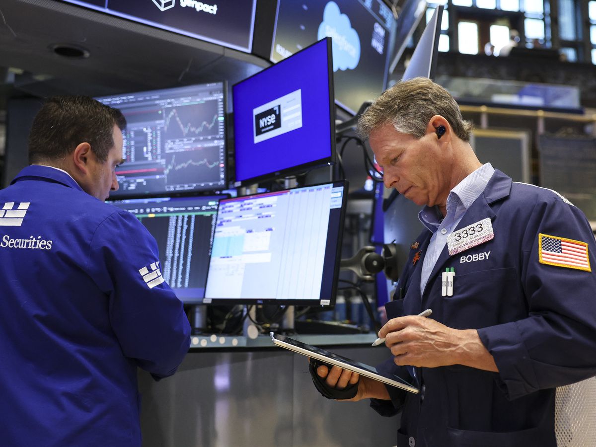 Traders work on the floor of the New York Stock Exchange (NYSE) at the opening bell in New York on May 27, 2026.
