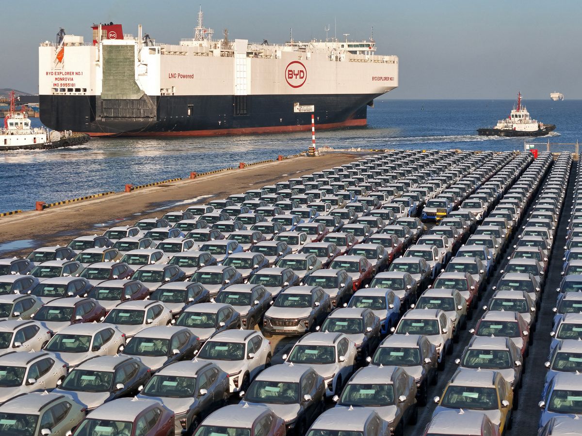 This photograph taken on January 10, 2024 shows electric cars for export waiting to be loaded on the "BYD Explorer NO.1", a domestically manufactured vessel intended to export Chinese automobiles, at Yantai port, in eastern China's Shandong province.