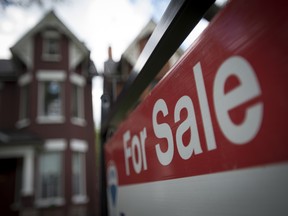 A home for sale, with a red and white REMAX for sale sign, in Toronto, Ontario.