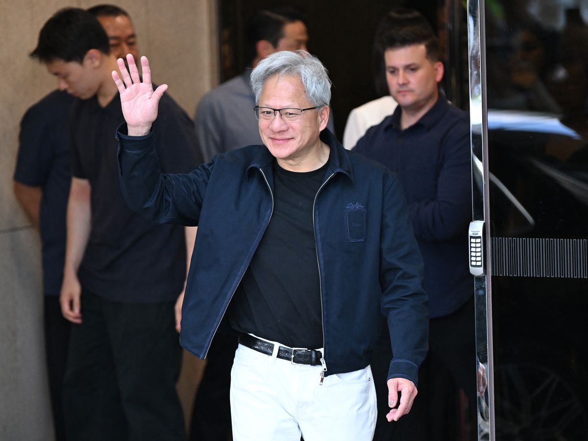 Nvidia CEO Jensen Huang waves to the media as he arrives at Gimpo airport in Seoul on June 5, 2026.