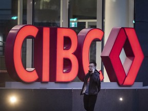 A person walks past CIBC signage in Toronto’s Financial District, Friday September 16, 2024