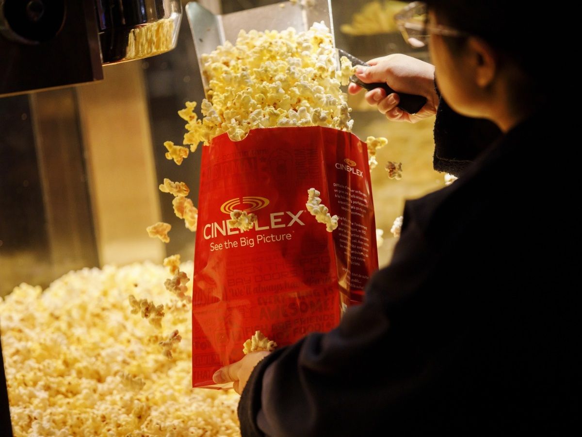 An employee fills a bag of popcorn in the concessions area inside a Cineplex Cinemas movie theater in Toronto, Ontario, Canada on Monday, Feb. 3, 2020.