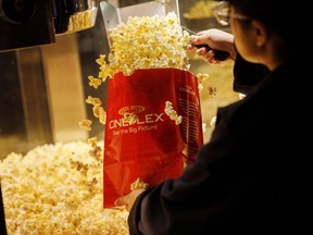 An employee fills a bag of popcorn in the concessions area inside a Cineplex Cinemas movie theater in Toronto, Ontario, Canada on Monday, Feb. 3, 2020.