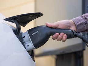 A man connects a Tesla electric vehicle to a DC/AC inverter at the University of Gävle on May 28, 2026 in Gävle, Sweden.